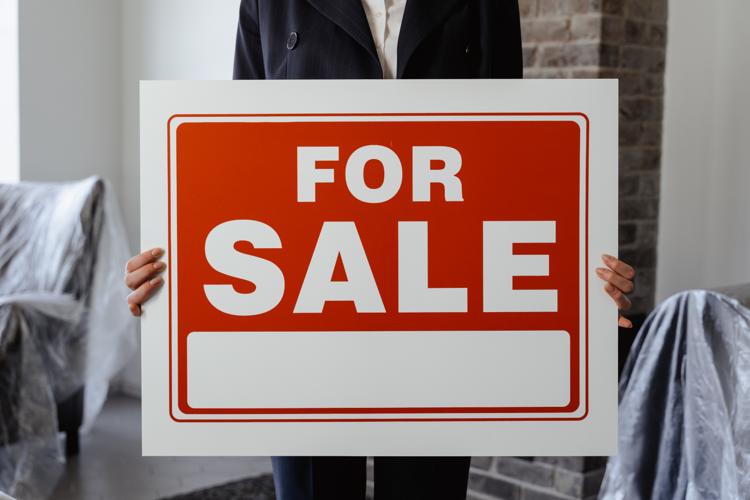 For sale sign in front of a house